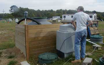 Test Center Operator Keith Mroczka inspects a innovative septic system.