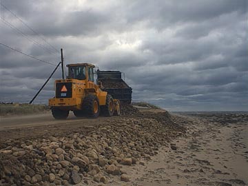 Town of Falmouth front end load working at a beach after Hurricane Floyd.